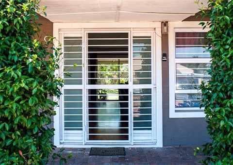 Magnador security swing gate on door with greenery