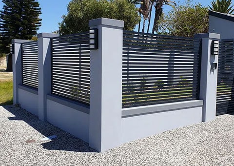 Black slatted panels set into grey concrete pillars