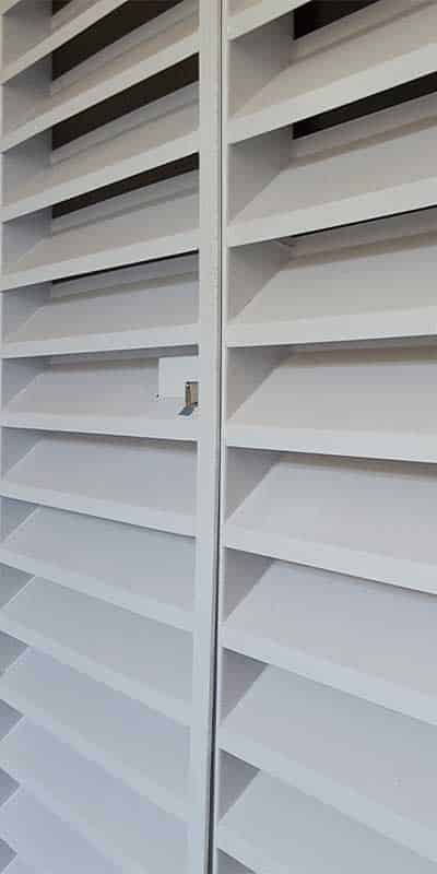 Powder-coated slatted panel welded at an angle to its frame